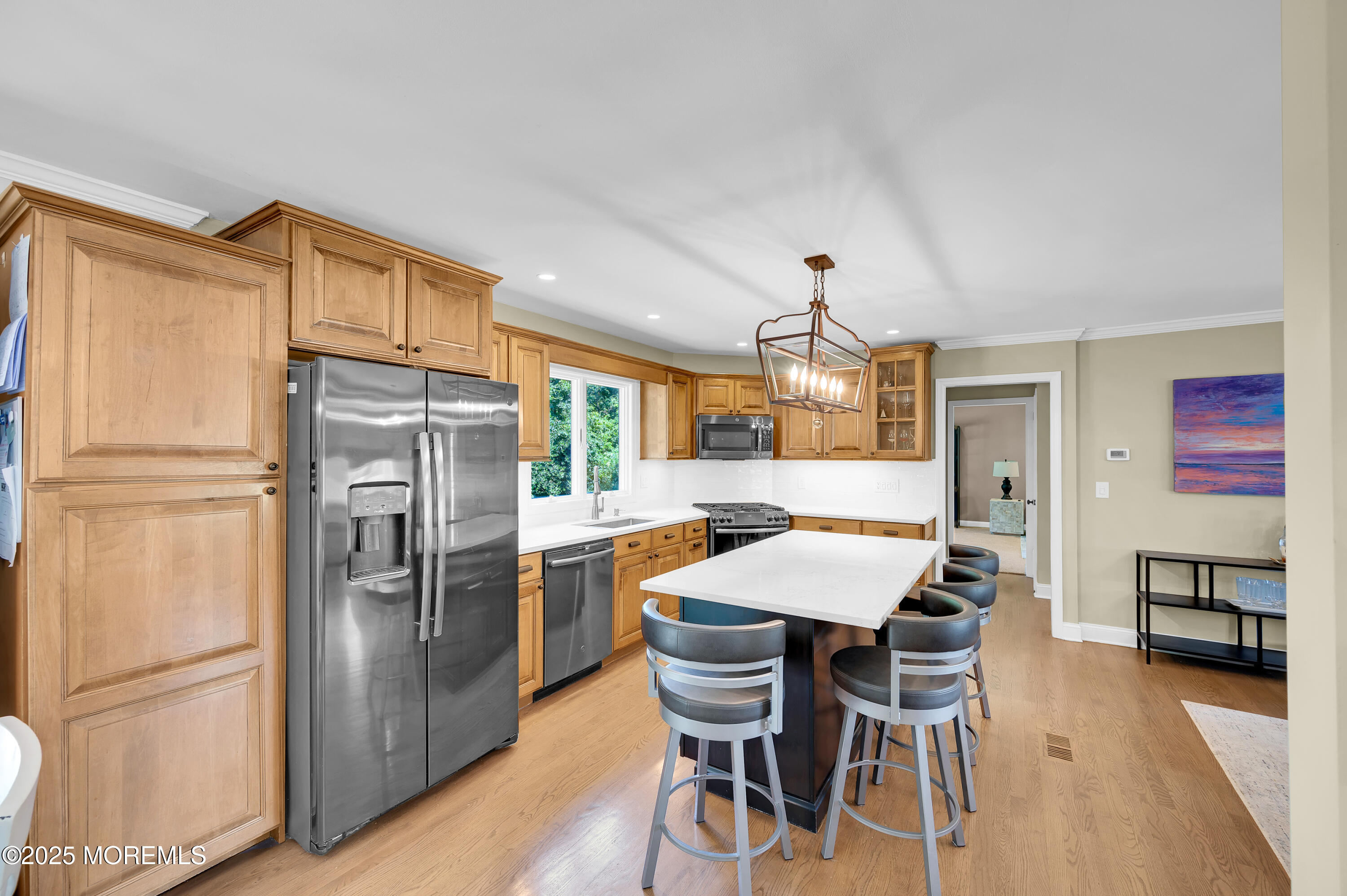 80 Robbins Court Brick, NJ 08724 - Photo 17 of 33 a kitchen with a refrigerator a dining table and chairs