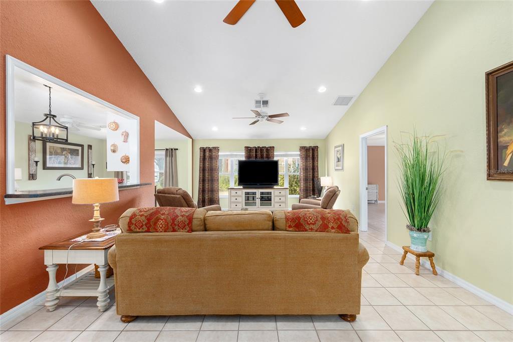11233 Southwest 73rd Circle Ocala, FL 34476 - Photo 15 of 53 a living room with furniture and a flat screen tv