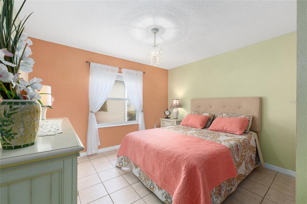 11233 Southwest 73rd Circle Ocala, FL 34476 - Photo 34 of 53 a bedroom with a bed and a table in it