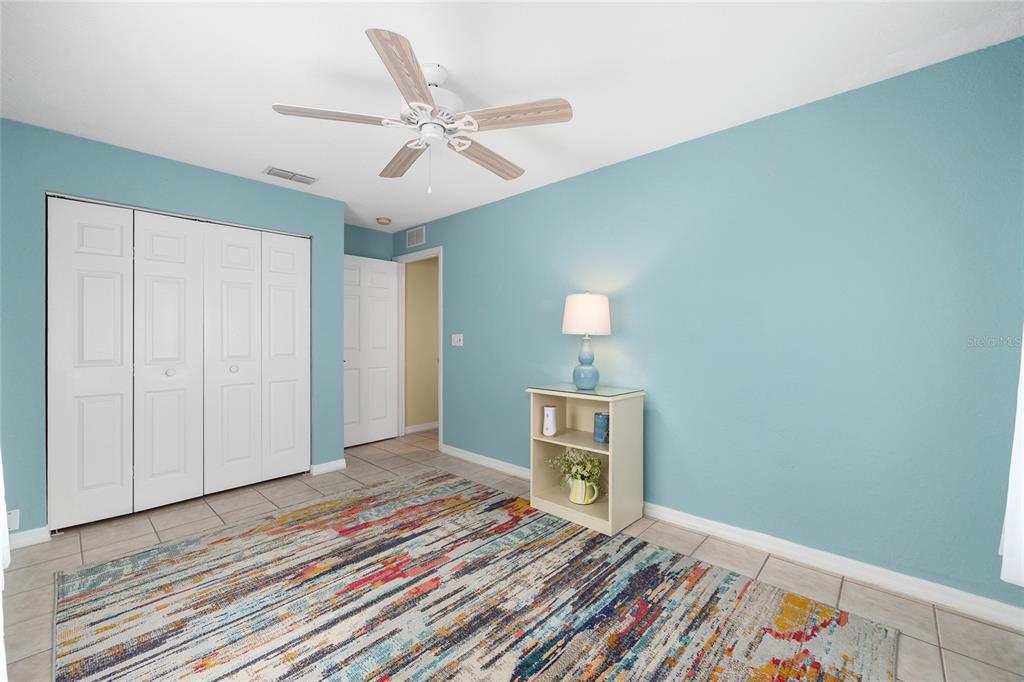 11233 Southwest 73rd Circle Ocala, FL 34476 - Photo 37 of 53 a bedroom with a bed and a chandelier