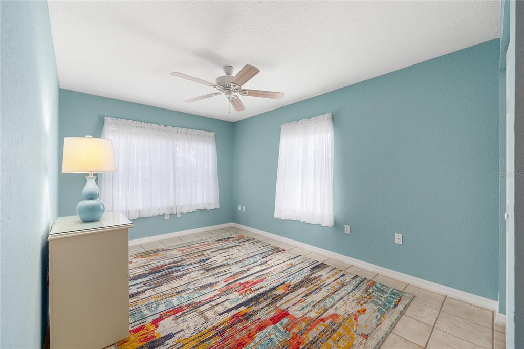 11233 Southwest 73rd Circle Ocala, FL 34476 - Photo 38 of 53 a bedroom with a bed and a lamp