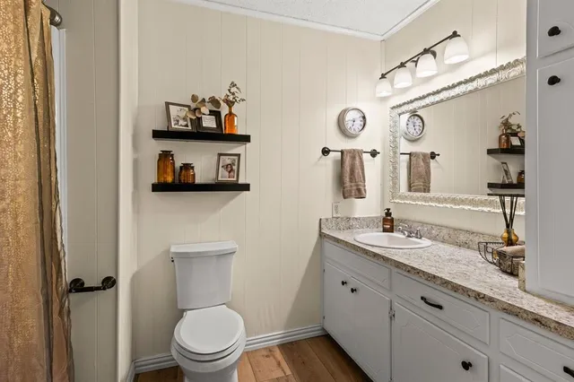 a bedroom with a white bed and a large window
