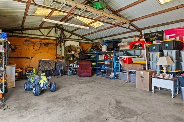 a view of a patio with table and chairs under an umbrella