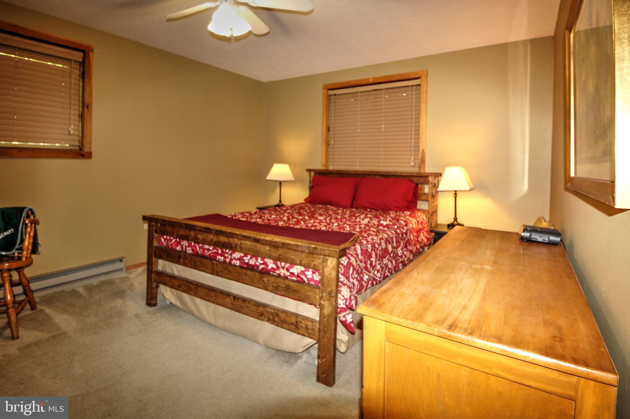 198 Hood's Point Road Basye, VA 22810 - Photo 15 of 23 a bedroom with a bed and a table in it