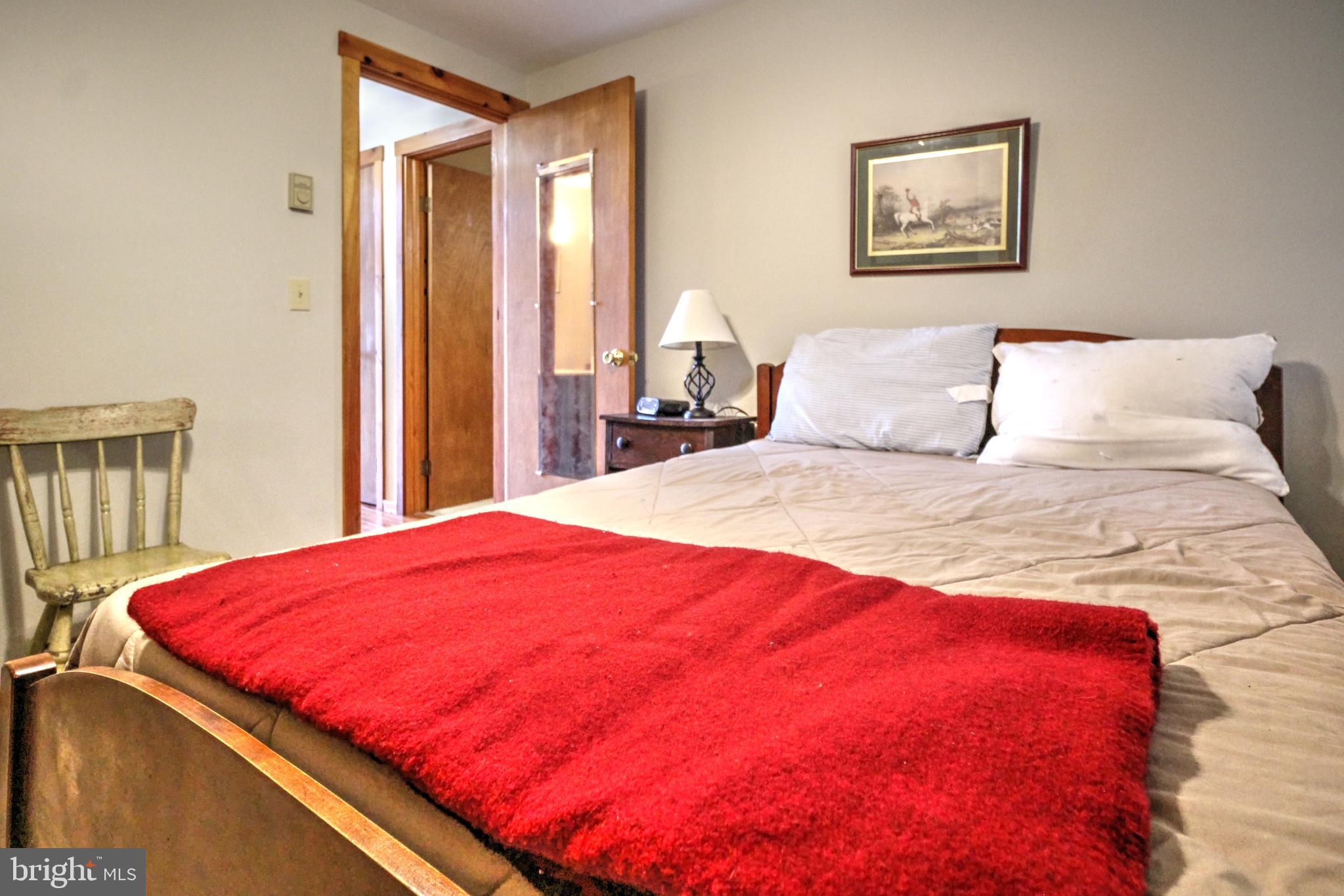 198 Hood's Point Road Basye, VA 22810 - Photo 17 of 23 a bedroom with a bed and a window