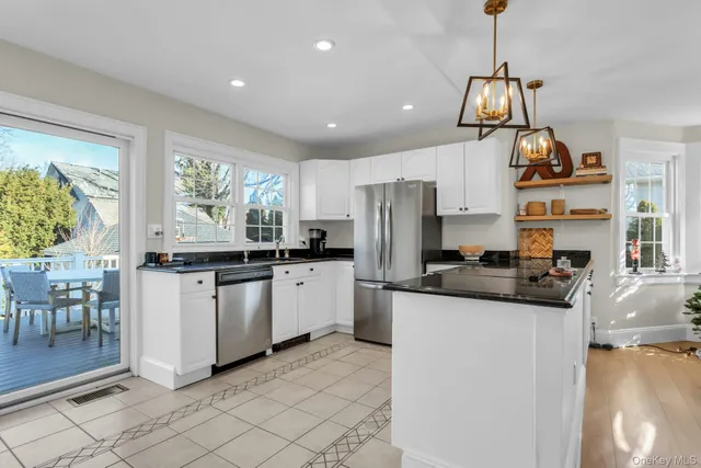 a kitchen with stainless steel appliances granite countertop a sink and cabinets