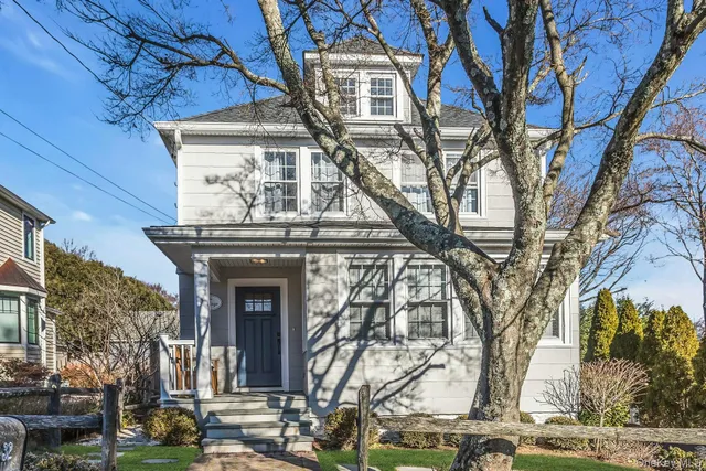 a front view of a building with trees