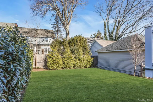 a view of a roof deck with table and chairs a barbeque with wooden floor and fence