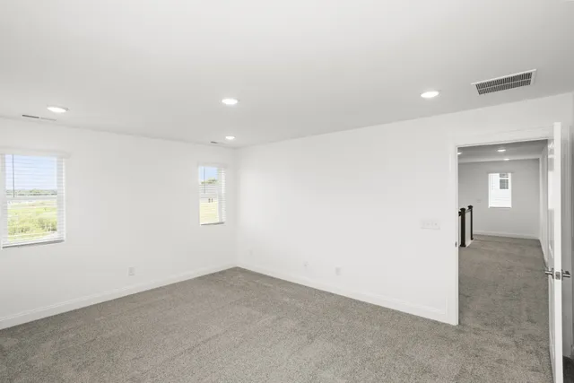 an empty room with a empty space and windows