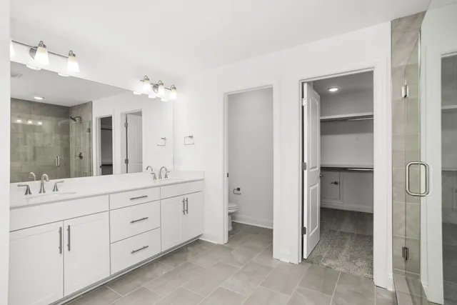 a bathroom with a double vanity sink shower and a mirror