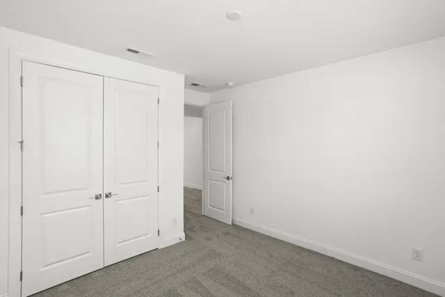 an empty room with closet area