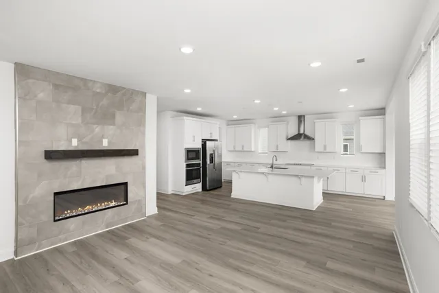 a large kitchen with a stove top oven and kitchen view