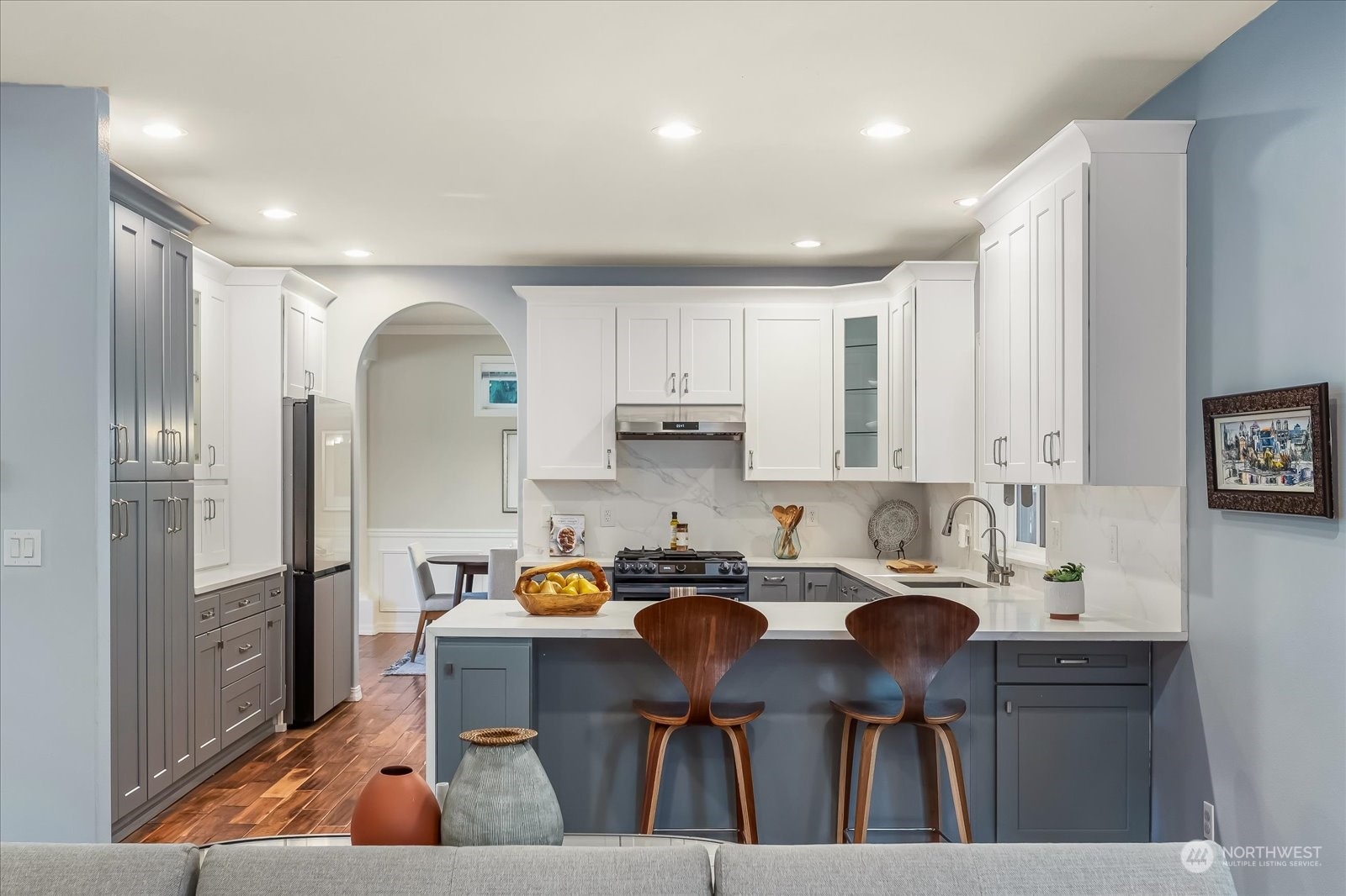 5407 Northeast 3rd Place Renton, WA 98059 - Photo 11 of 39 a kitchen with a sink chairs and refrigerator