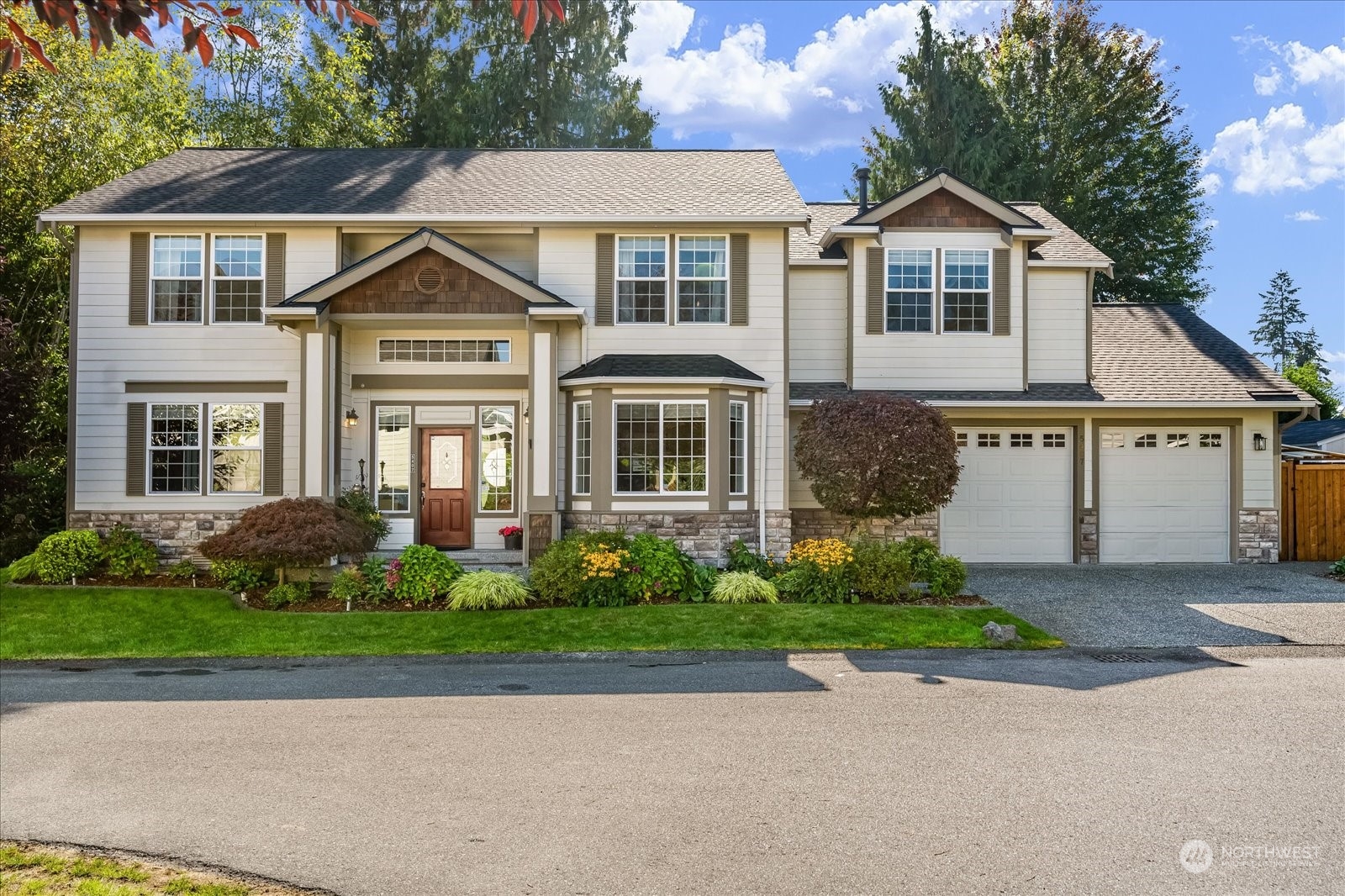 5407 Northeast 3rd Place Renton, WA 98059 - Photo 2 of 39 a front view of a house with a garden and trees