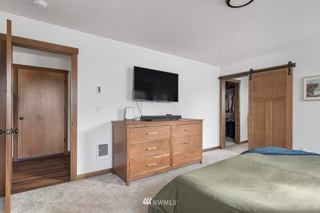 1471 North View Road Oak Harbor, WA 98277 - Photo 19 of 38 a bedroom with a bed and a flat screen tv