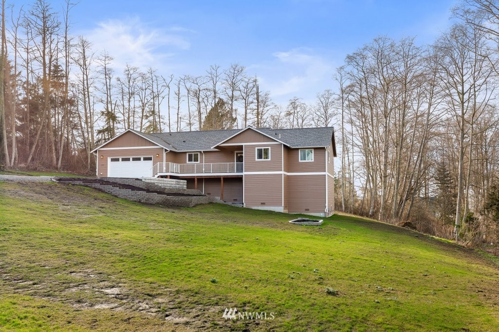 1471 North View Road Oak Harbor, WA 98277 - Photo 4 of 38 a aerial view of a house next to a big yard and large trees