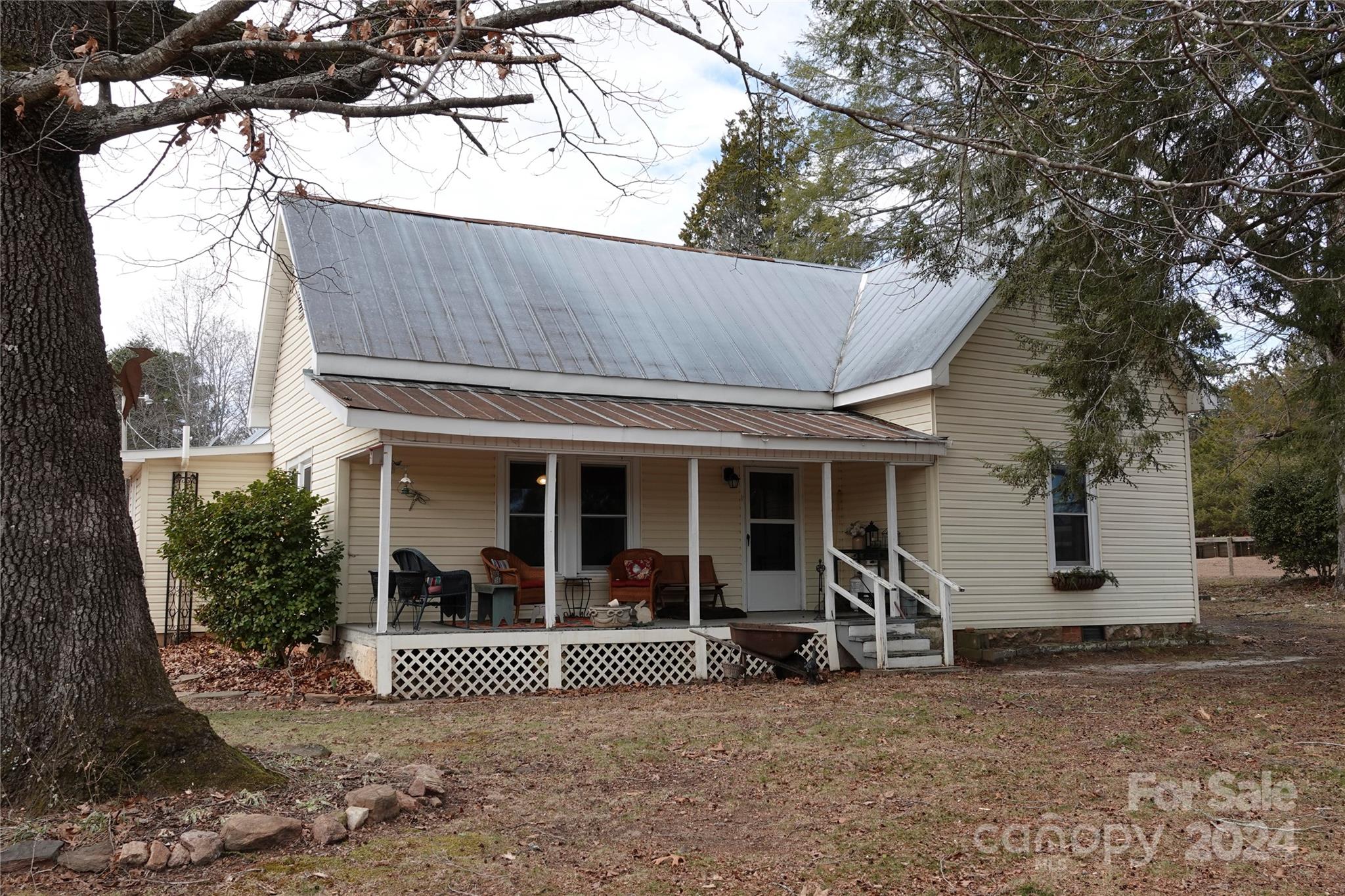 1276 Golf Course Road Tryon, NC 28782 - Photo 1 of 28 a view of a house with a yard and sitting area