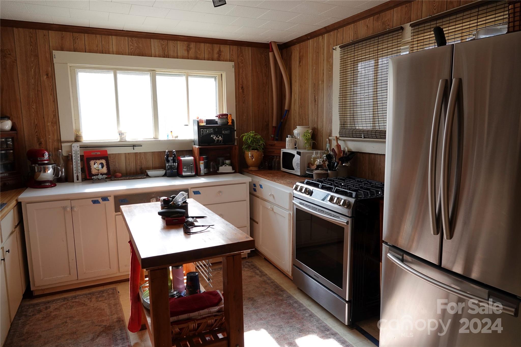 1276 Golf Course Road Tryon, NC 28782 - Photo 17 of 28 a kitchen with a refrigerator stove and sink