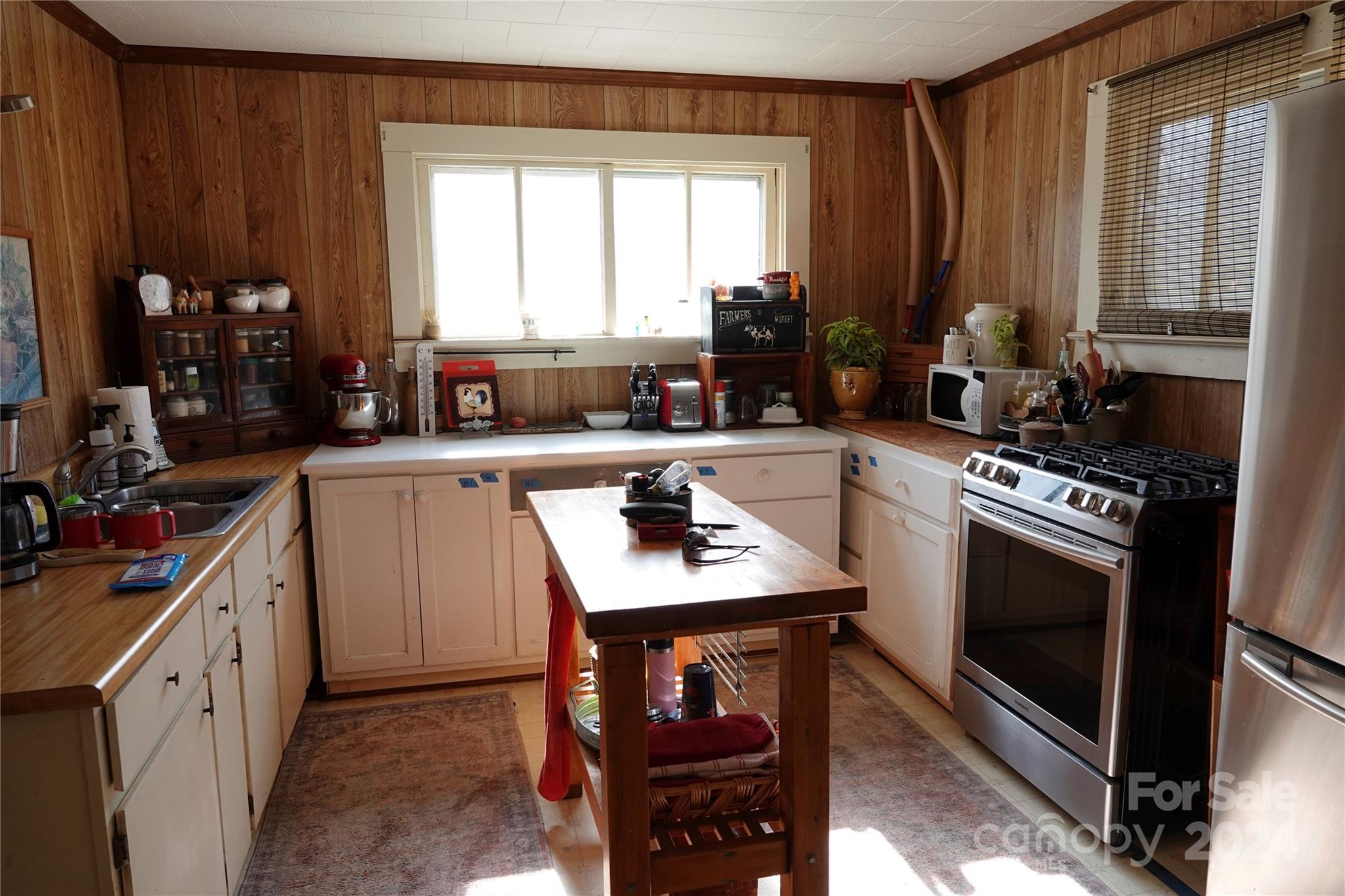 1276 Golf Course Road Tryon, NC 28782 - Photo 19 of 28 a kitchen with stainless steel appliances granite countertop a sink stove and cabinets