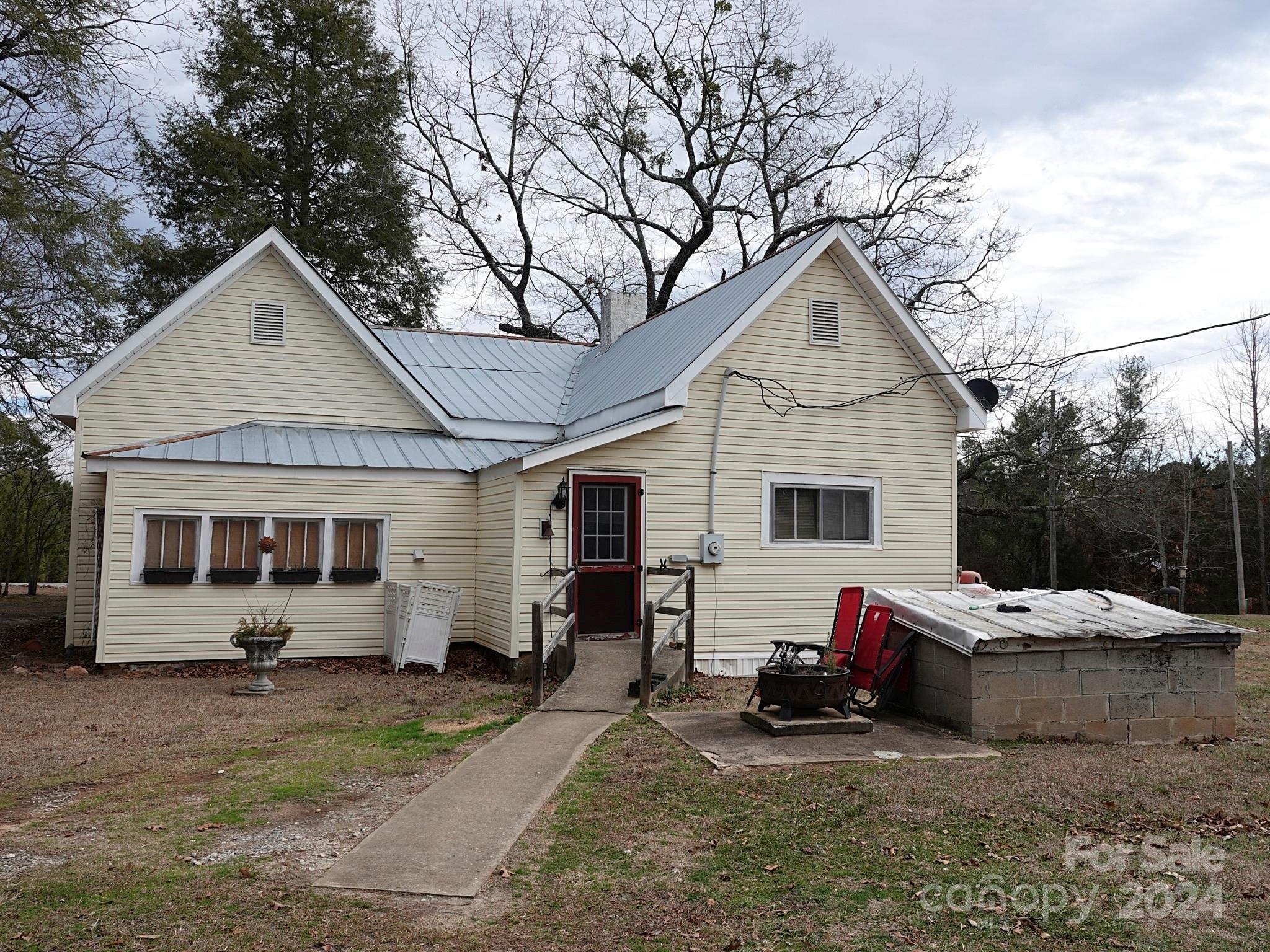 1276 Golf Course Road Tryon, NC 28782 - Photo 4 of 28 a front view of a house with cars parked