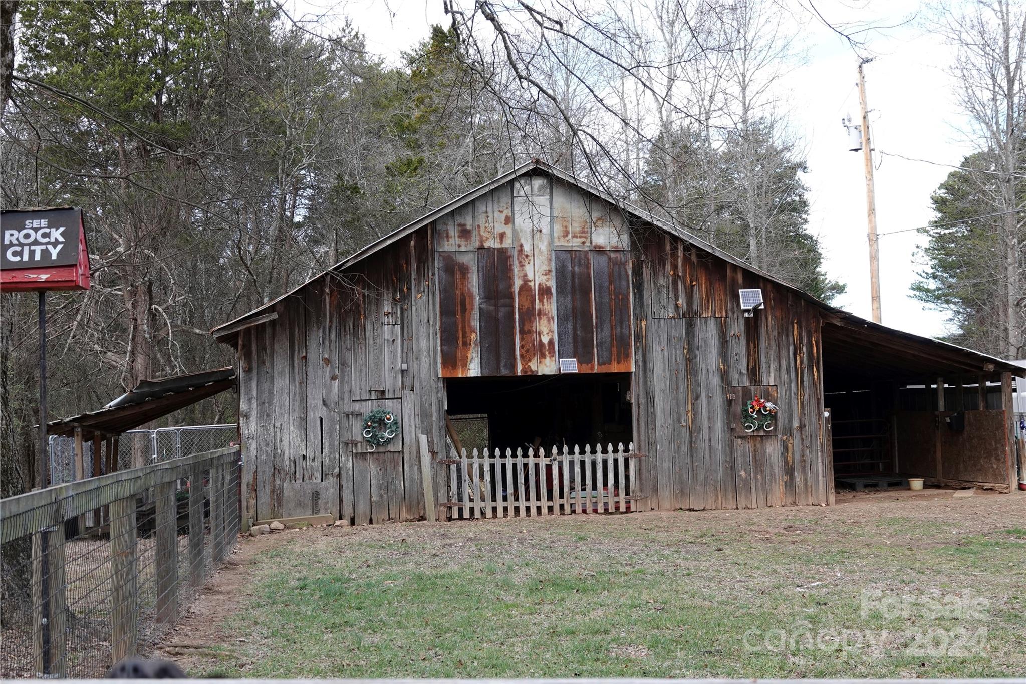 1276 Golf Course Road Tryon, NC 28782 - Photo 7 of 28 a view of a wooden house with a small yard