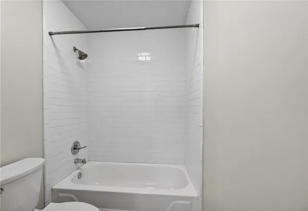 a bathroom with a bathtub and a toilet
