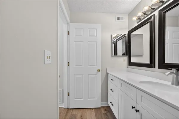 a spacious bathroom with a double vanity sink and mirror