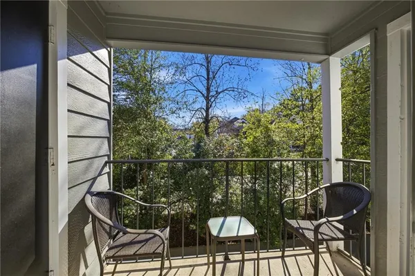 a view of a balcony with chairs and a table