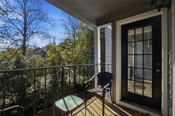a view of a balcony with chair and wooden floor