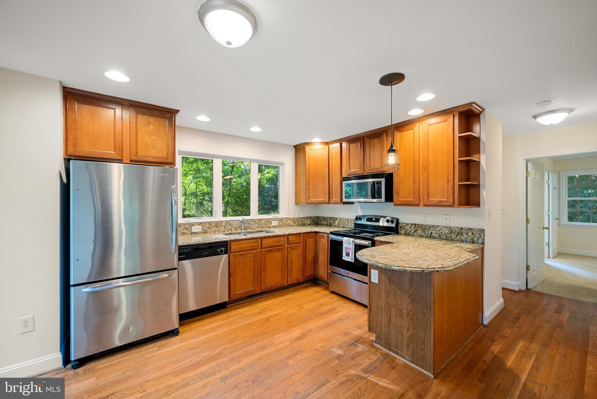 175 Easy Hollow Road Front Royal, VA 22630 - Photo 12 of 42 a large kitchen with stainless steel appliances granite countertop a refrigerator a sink dishwasher a oven and a large window