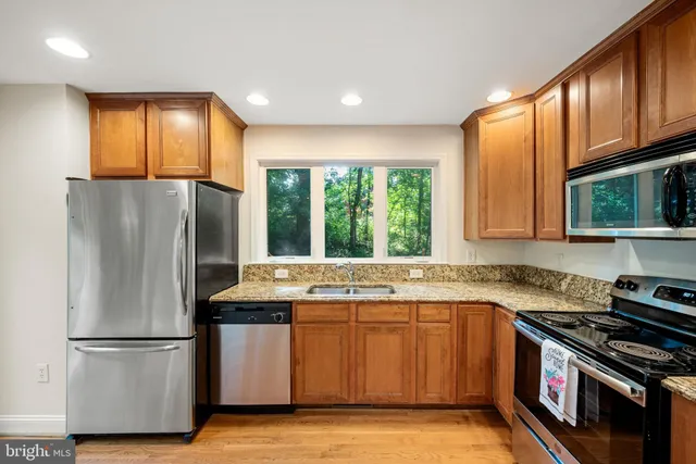 a kitchen with a stove a sink and a refrigerator