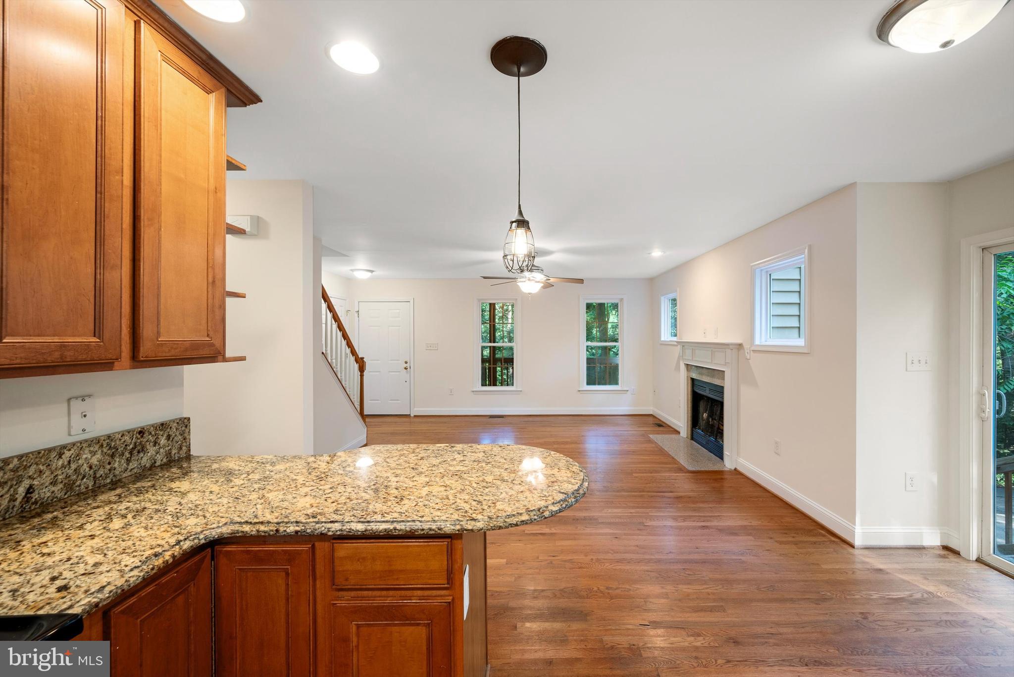 175 Easy Hollow Road Front Royal, VA 22630 - Photo 16 of 42 a kitchen with kitchen island granite countertop wooden floor and a refrigerator