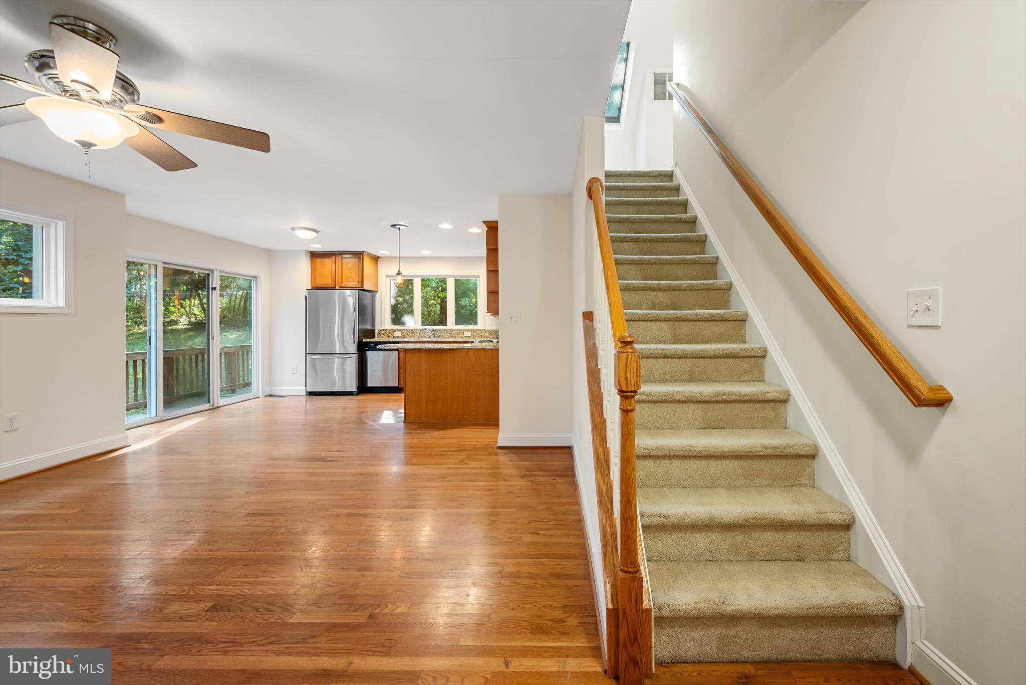 175 Easy Hollow Road Front Royal, VA 22630 - Photo 19 of 42 a view of an entryway with wooden floor leading to a furnished livingroom and windows