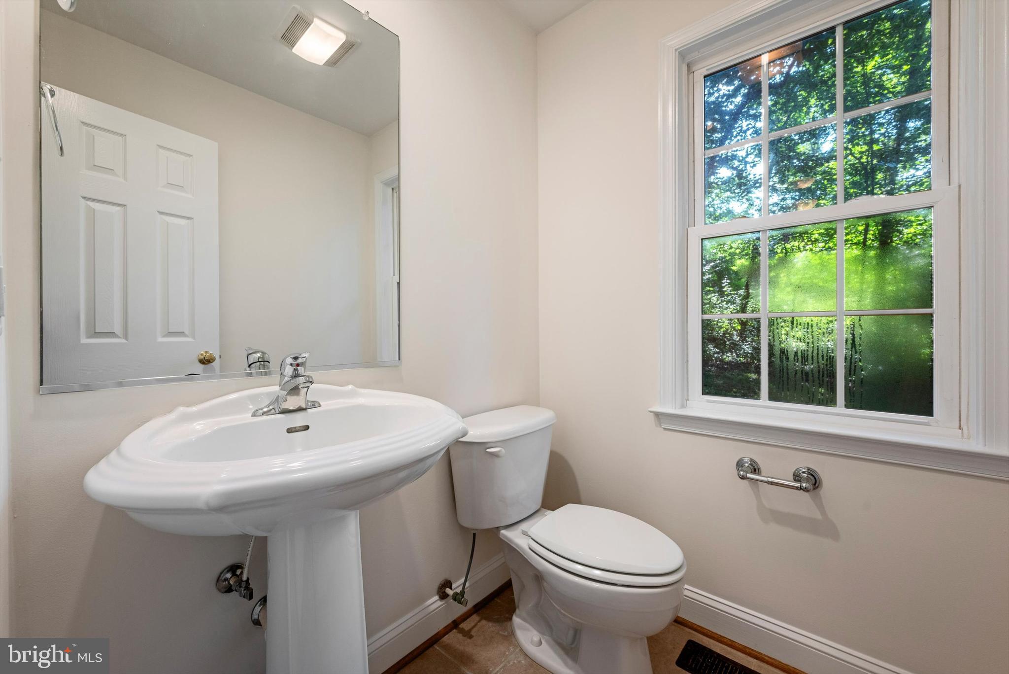 175 Easy Hollow Road Front Royal, VA 22630 - Photo 20 of 42 a bathroom with a sink a toilet and a mirror