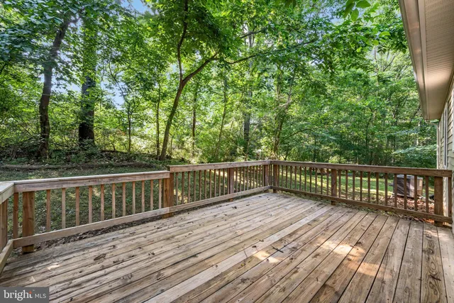 a view of balcony with wooden floor and fence