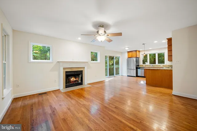 a view of an empty room with a fireplace and a window