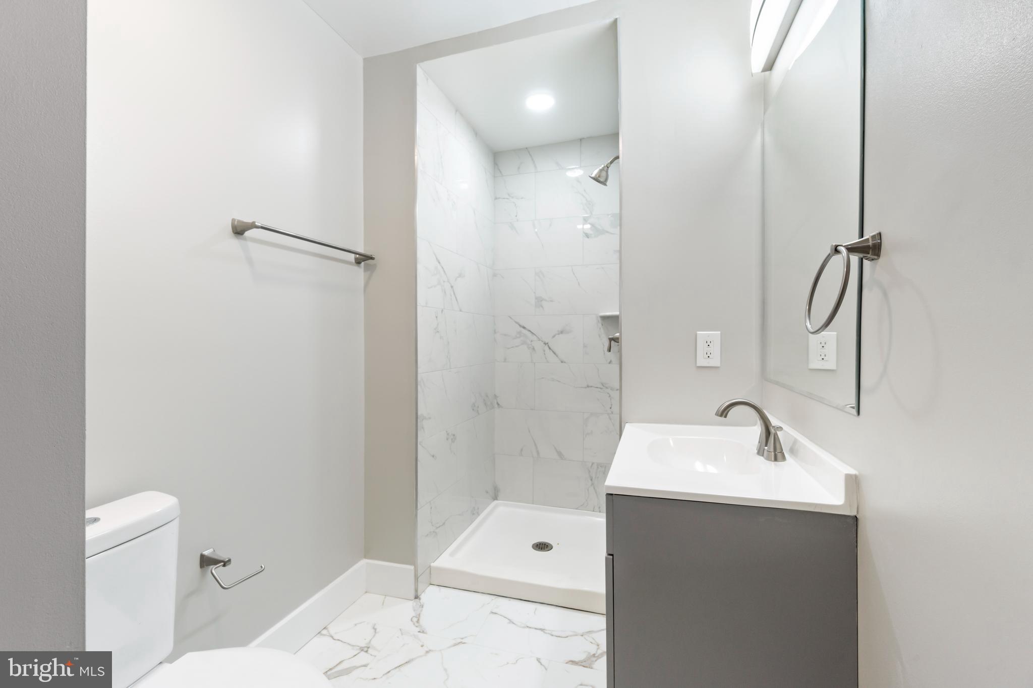 4534 Old Court Road Baltimore, MD 21208 - Photo 12 of 26 a bathroom with a sink a toilet and shower