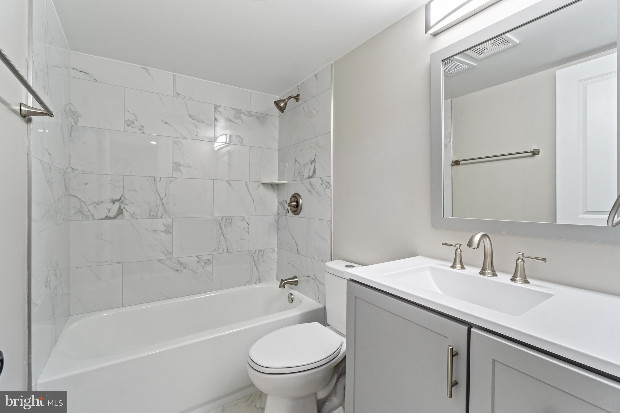4534 Old Court Road Baltimore, MD 21208 - Photo 16 of 26 a bathroom with a sink a toilet and a bathtub