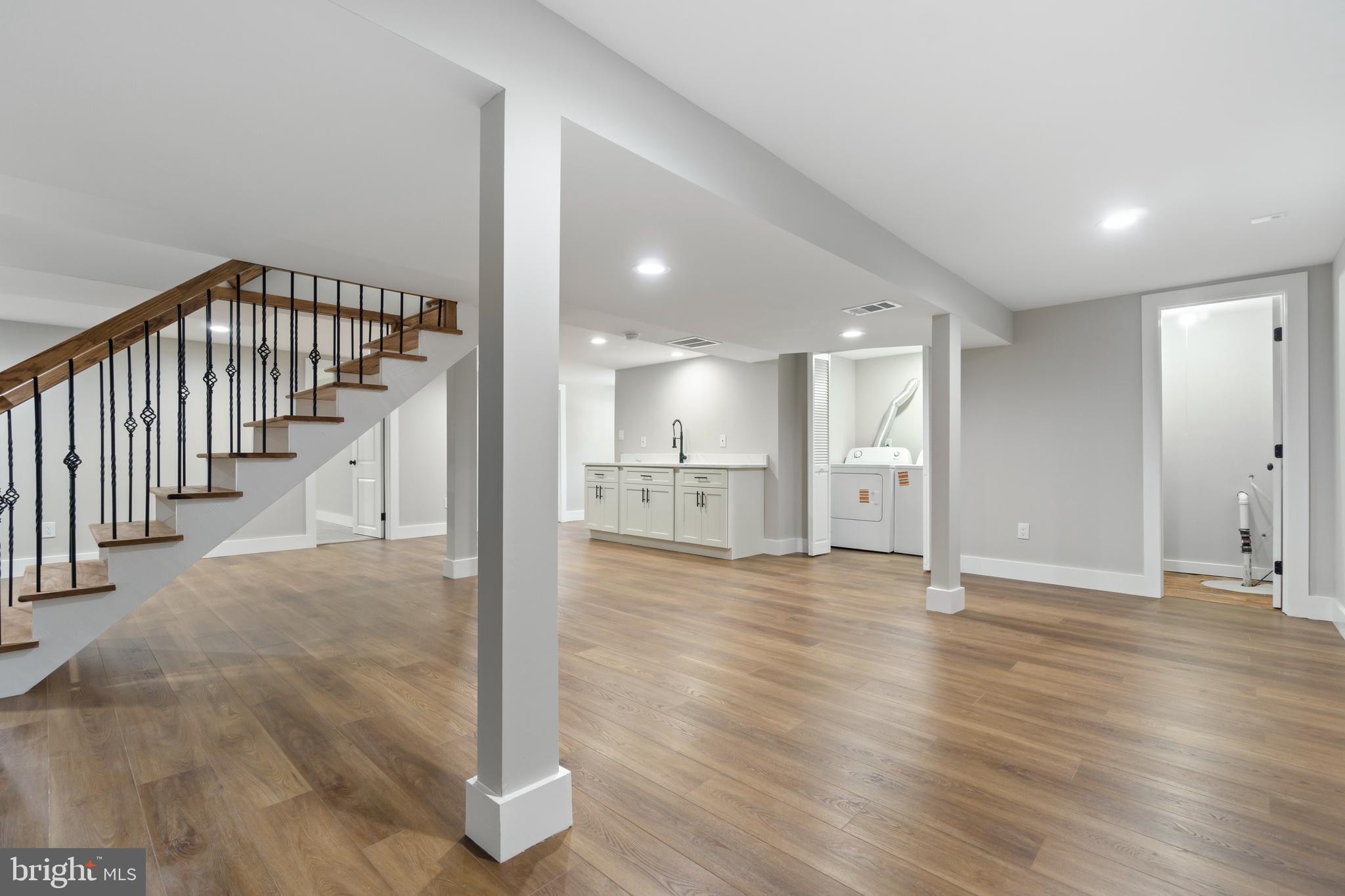 4534 Old Court Road Baltimore, MD 21208 - Photo 19 of 26 a view of an empty room with wooden floor and a window