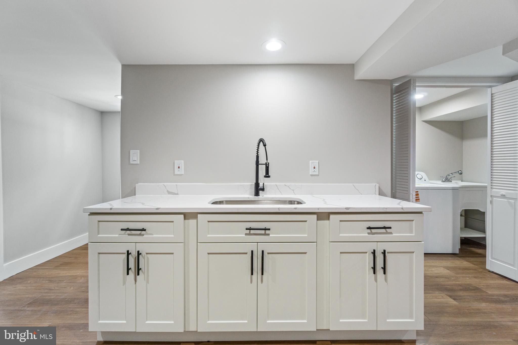 4534 Old Court Road Baltimore, MD 21208 - Photo 20 of 26 a kitchen with white cabinets and sink