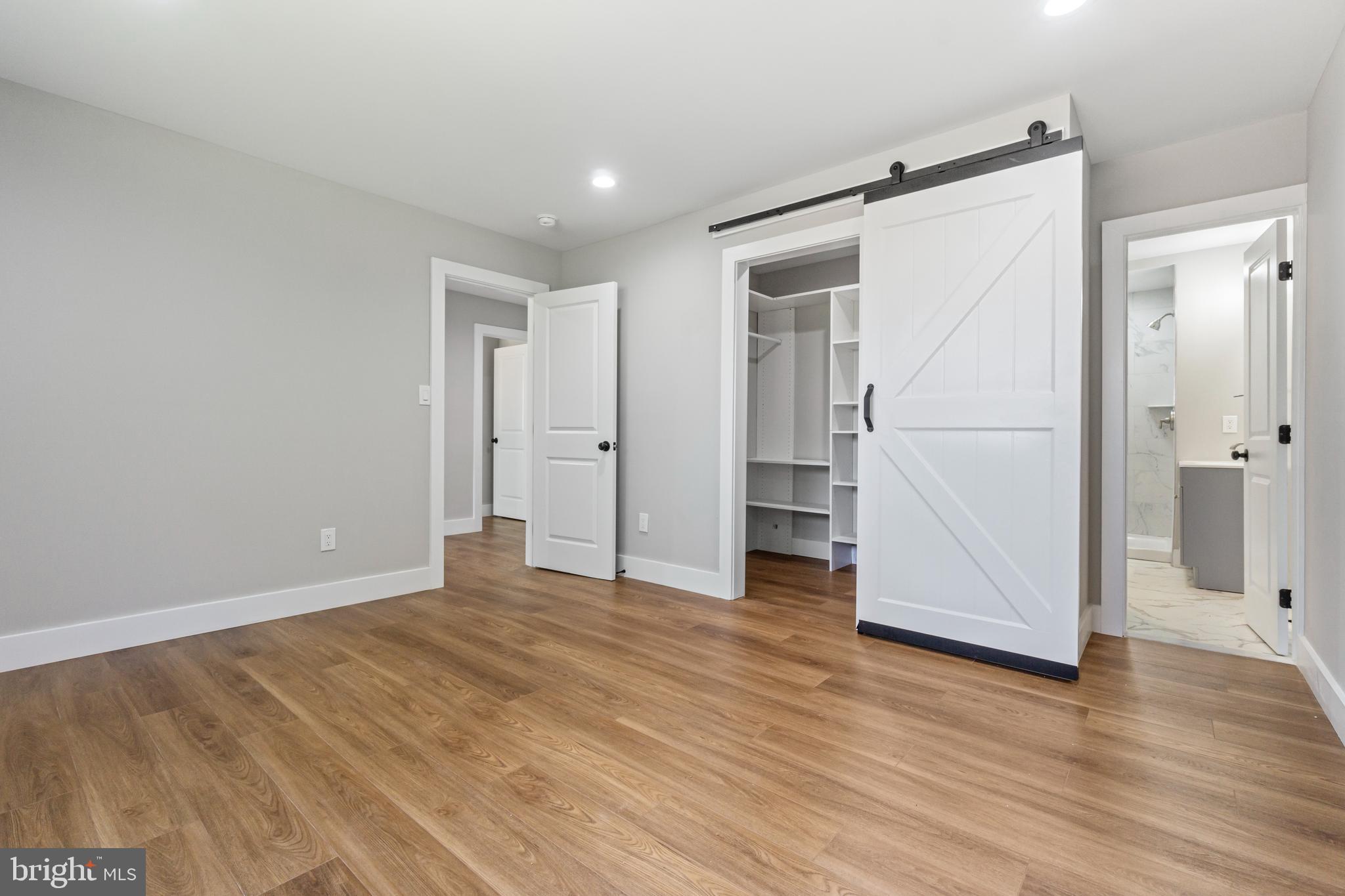 4534 Old Court Road Baltimore, MD 21208 - Photo 10 of 26 an empty room with wooden floor and a refrigerator