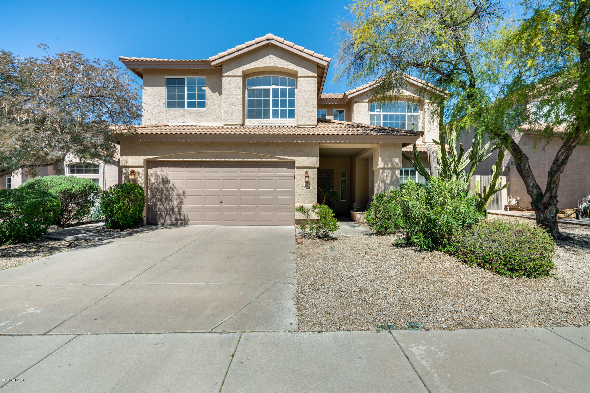 a front view of a house with a yard and garage
