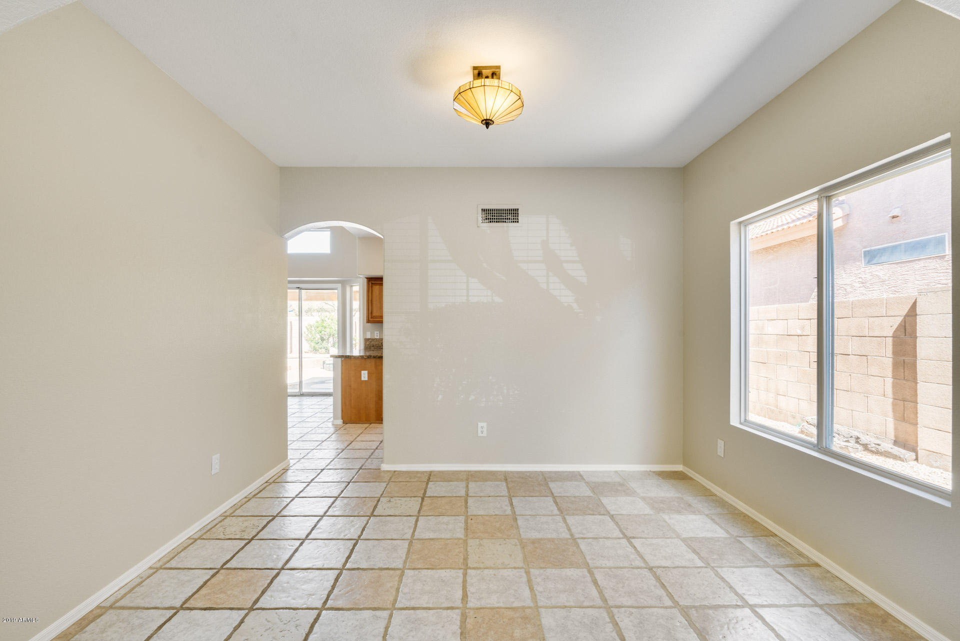 4522 East Rowel Road Phoenix, AZ 85050 - Photo 11 of 37 a view of an empty room with window and chandelier fan