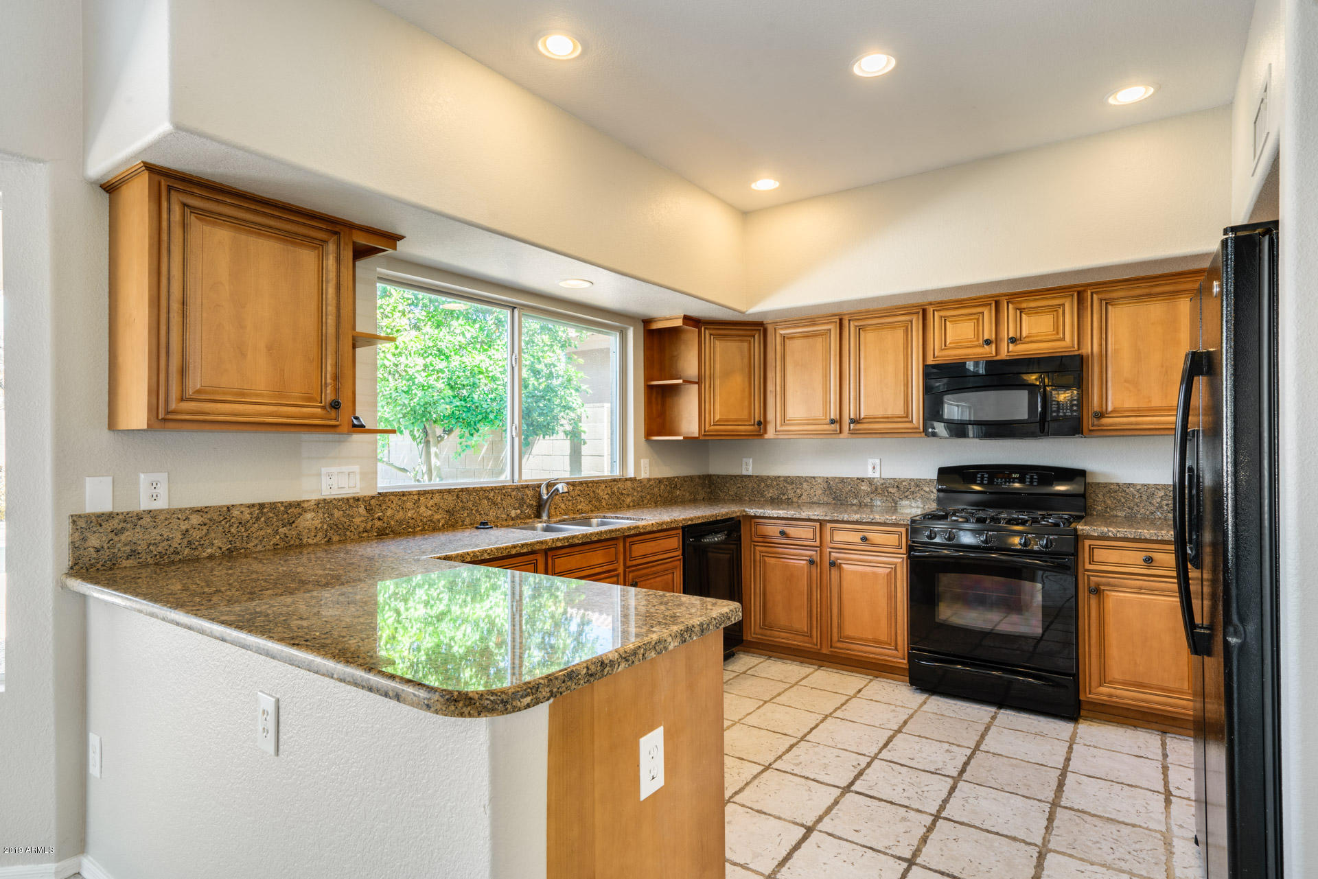 4522 East Rowel Road Phoenix, AZ 85050 - Photo 13 of 37 a kitchen with stainless steel appliances granite countertop a stove a sink and a microwave