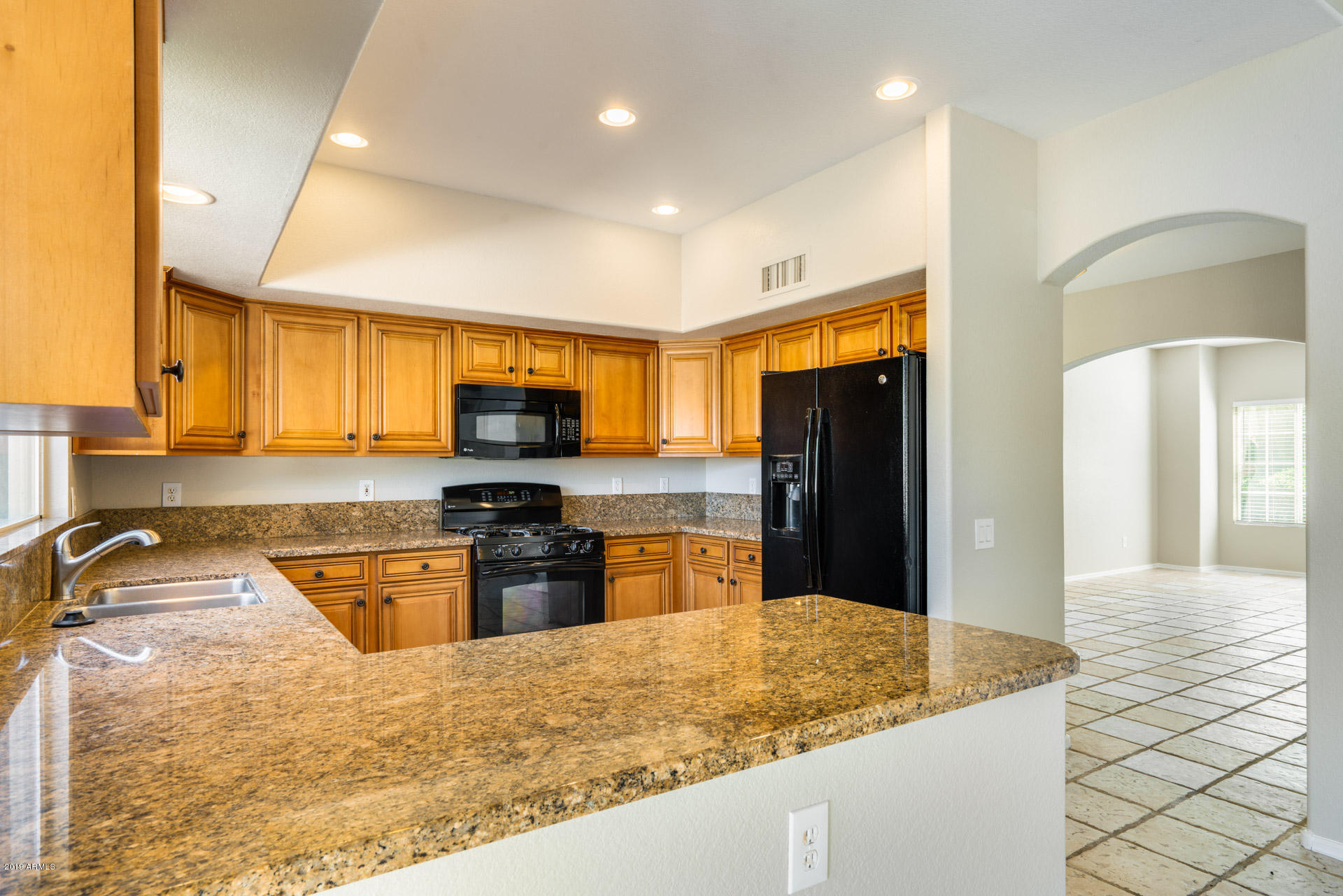 4522 East Rowel Road Phoenix, AZ 85050 - Photo 14 of 37 a kitchen with stainless steel appliances granite countertop a refrigerator stove microwave and sink