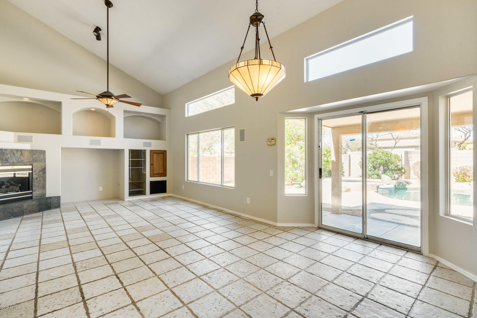 4522 East Rowel Road Phoenix, AZ 85050 - Photo 16 of 37 a view of an empty room with a window and chandelier