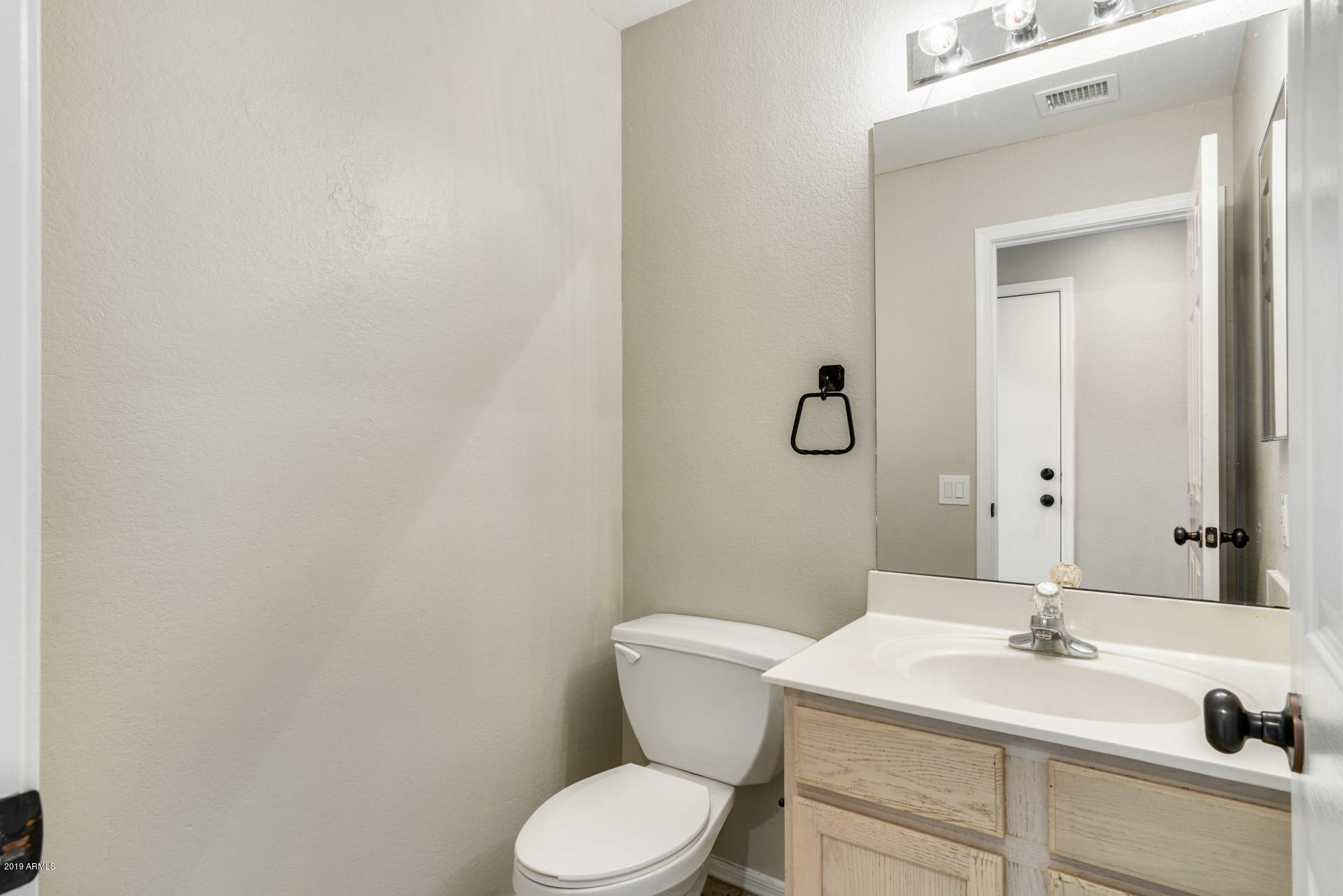 4522 East Rowel Road Phoenix, AZ 85050 - Photo 19 of 37 a bathroom with a toilet sink and mirror