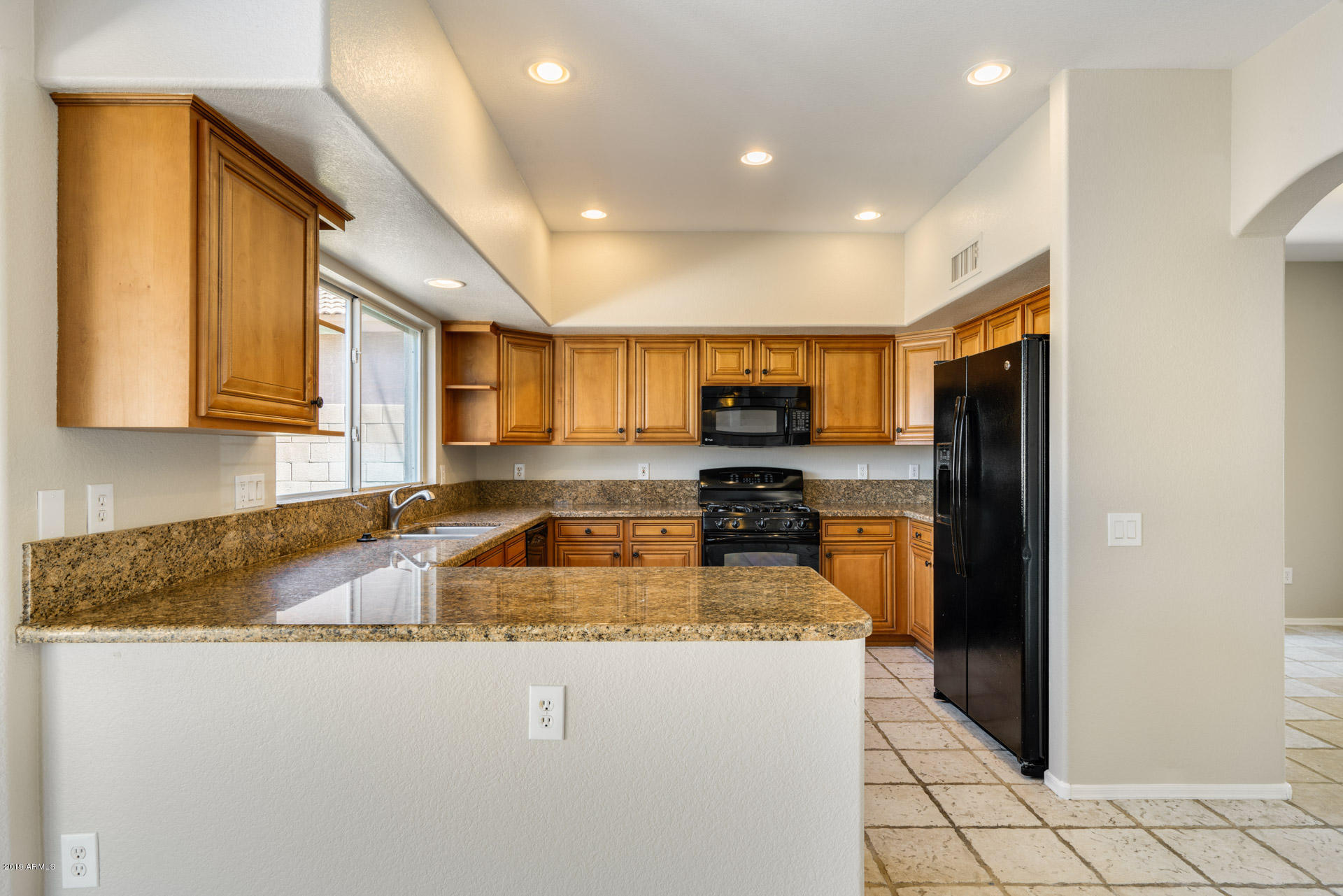 4522 East Rowel Road Phoenix, AZ 85050 - Photo 2 of 37 a large kitchen with stainless steel appliances granite countertop a refrigerator a stove a sink and a microwave
