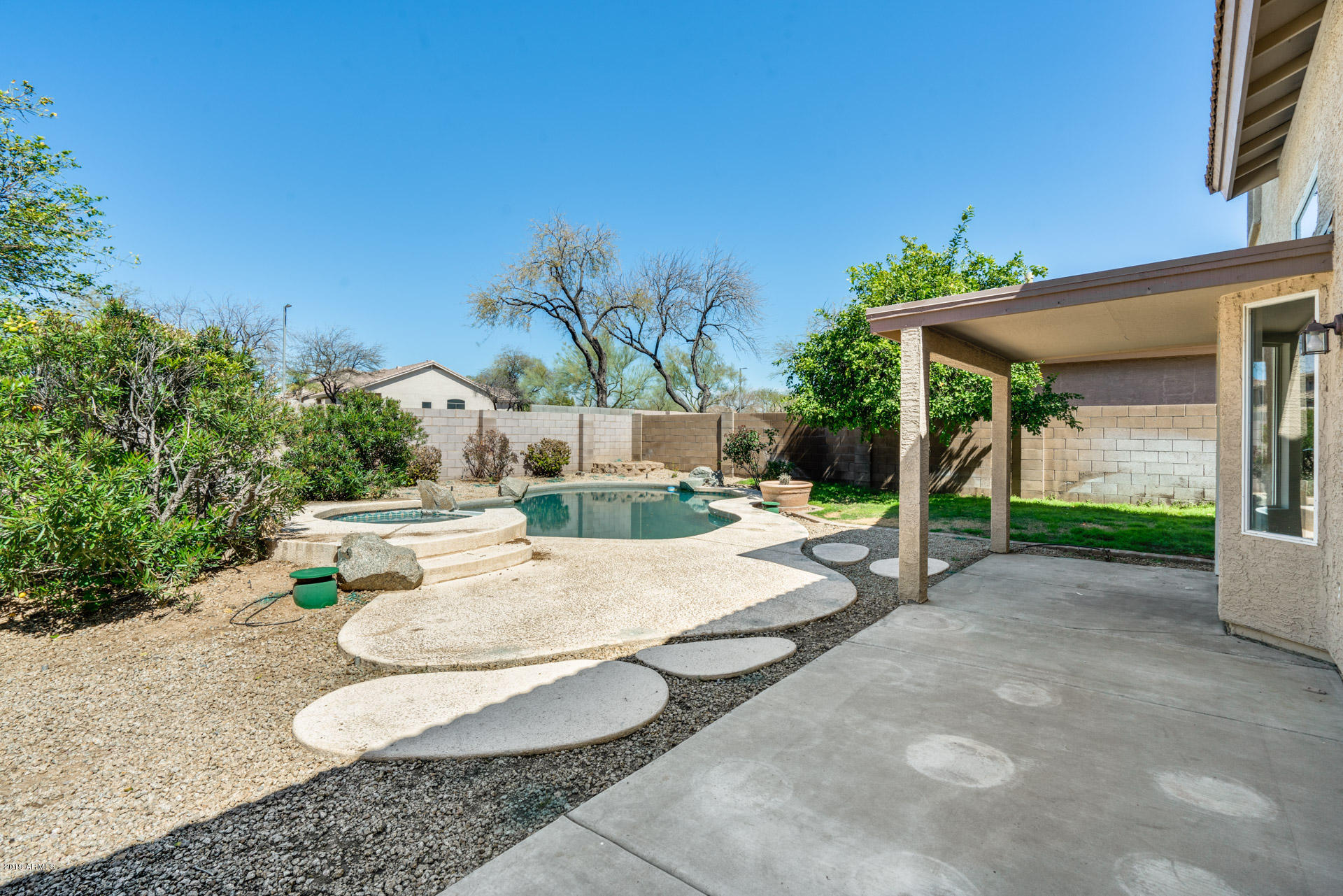 4522 East Rowel Road Phoenix, AZ 85050 - Photo 34 of 37 a backyard of a house with table and chairs