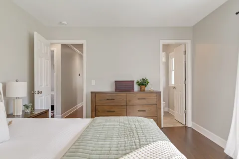 a bedroom with furniture and a book shelf